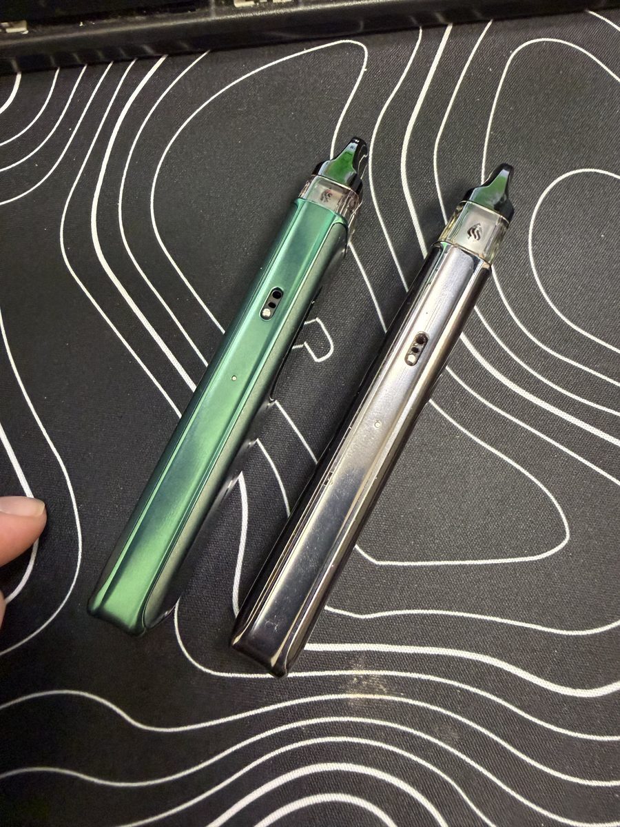 Vaporesso XROS 6 and XROS 5 held together showing the Silk Green and silver finishes