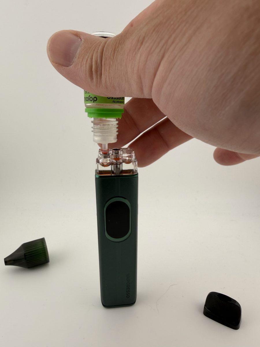 Refilling a Vaporesso XROS 6 COREX 3.0 pod through the red top fill port