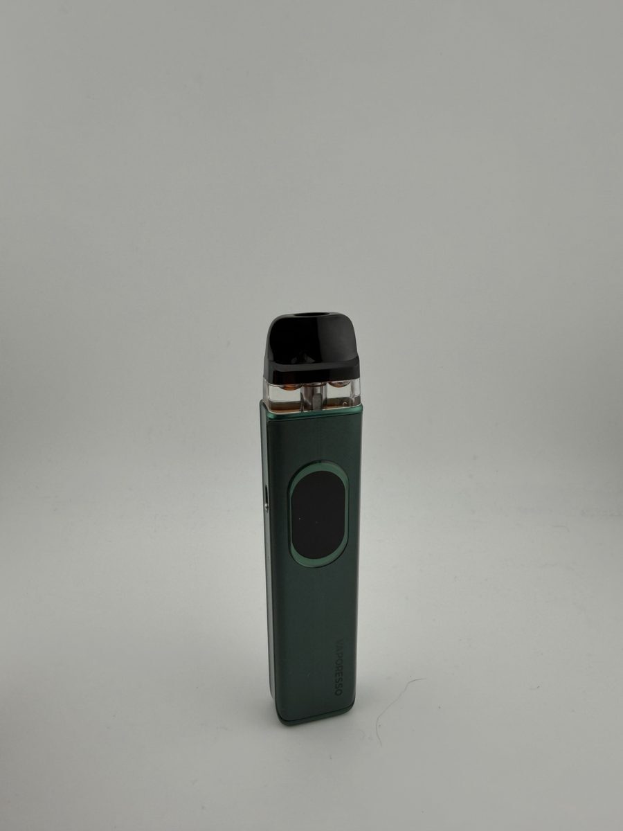 Vaporesso XROS 6 with the pod top cap removed, sitting next to the device