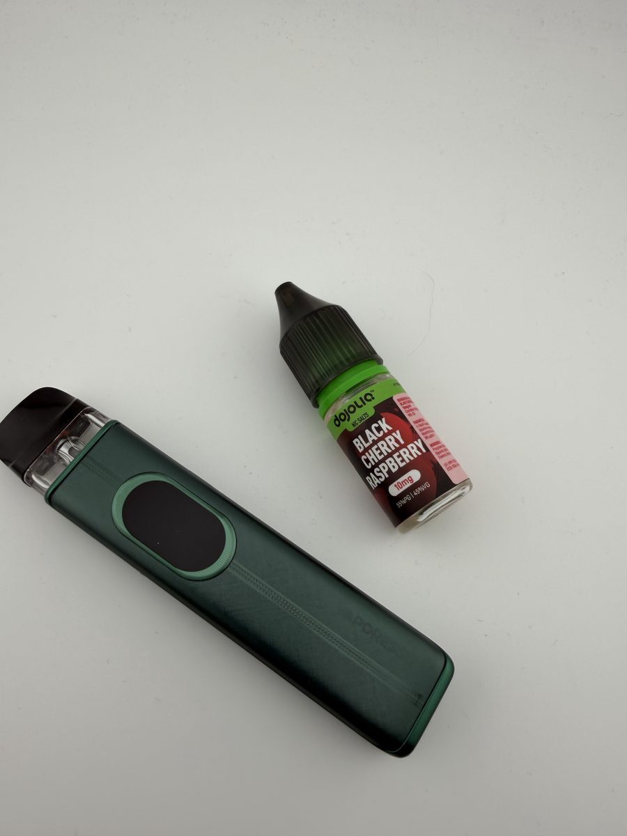 Vaporesso XROS 6 laid flat showing the brushed texture and pinstripe detail on the body