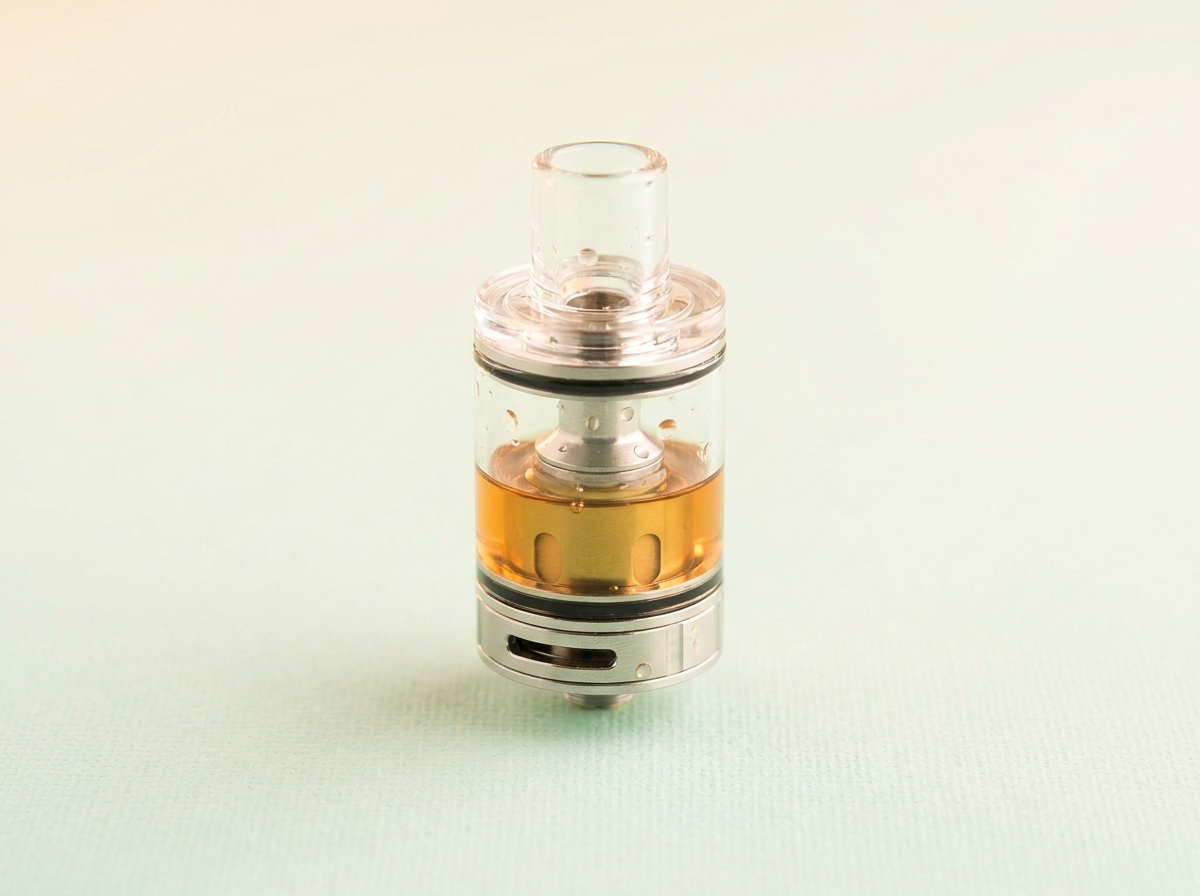 A clear glass sub-ohm vape tank filled with e-liquid