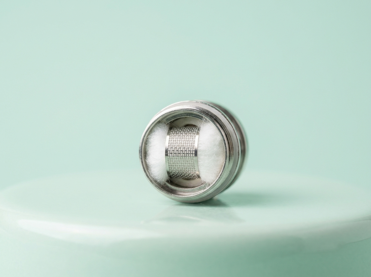 A replacement vape coil showing its mesh and cotton wicking